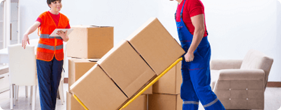 Furniture movers in Sharjah carrying a wardrobe